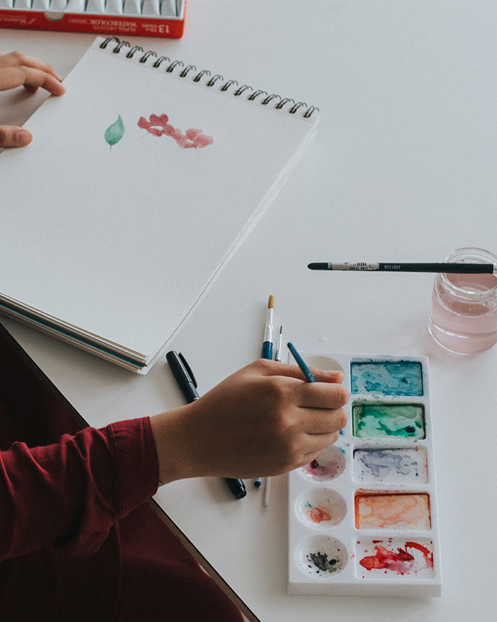 Person creating art on the paper