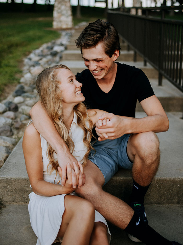 Couple sitting, holding hands and smiling