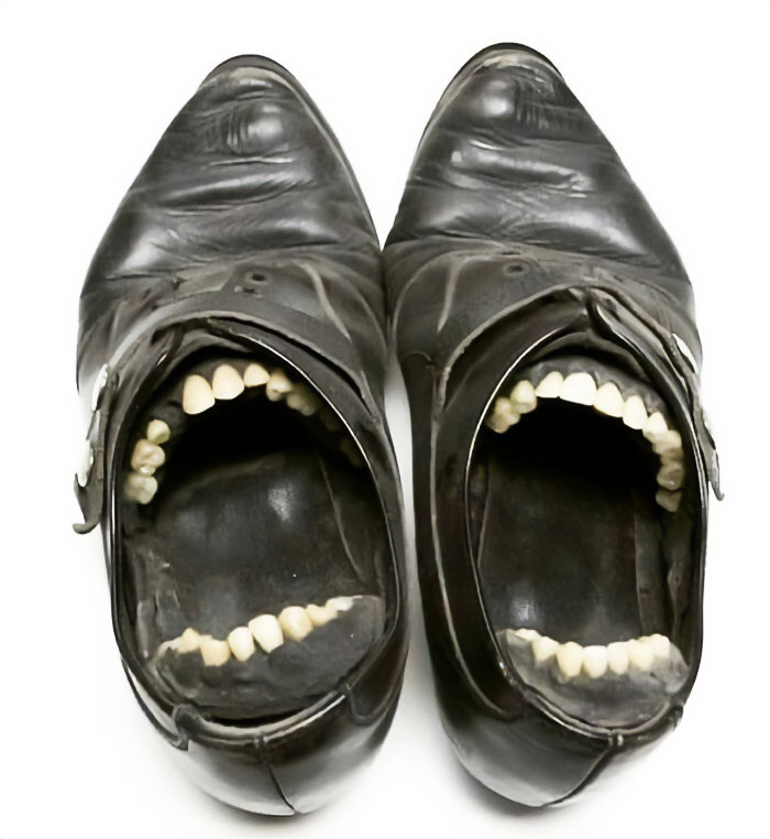 Weird shoes with lifelike teeth inside the toe area, creating a bizarre and uncanny appearance.
