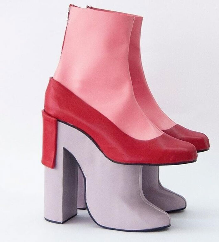 Unusual shoes with red and pink upper and layered platform heel design.