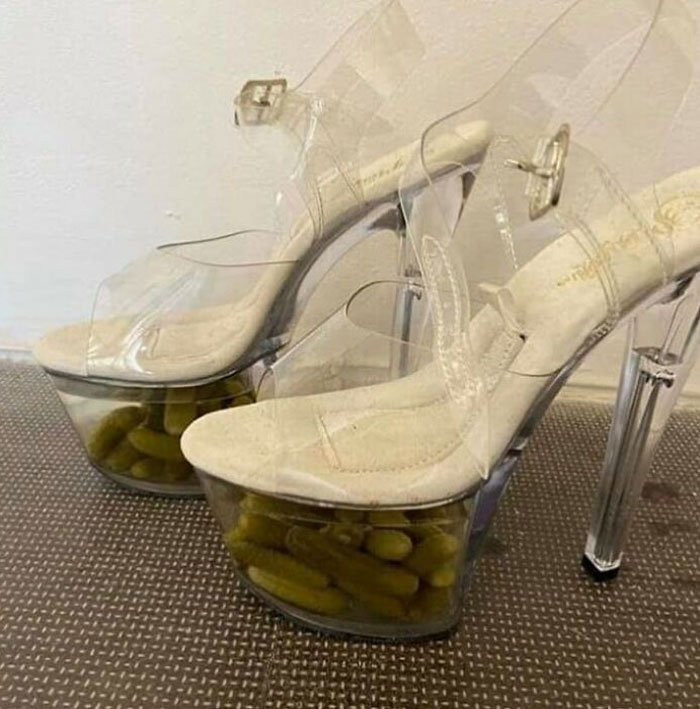 Weird shoes with clear platform heels filled with pickles.