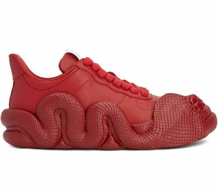 Red weird shoe with snake-like texture and unique design.