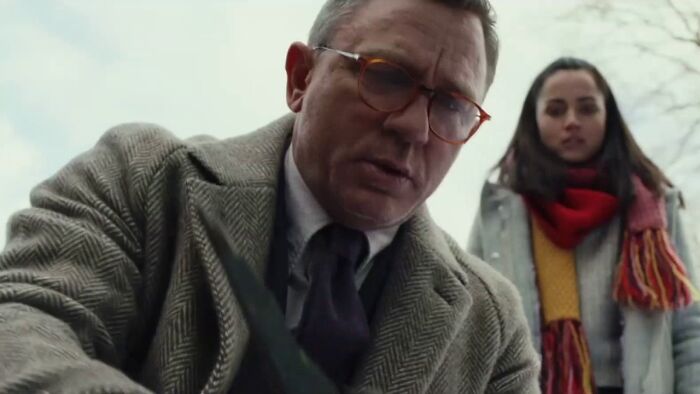 Close-up of two actors in outdoor scene, representing some of the highest-paid actors with serious expressions and winter clothing.