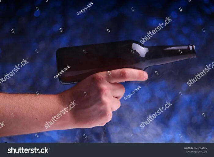 Just A Bottle Being Held Like A Gun