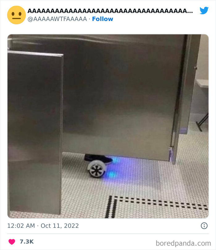 Weird and funny image of a bathroom stall with a wheel and blue light underneath.