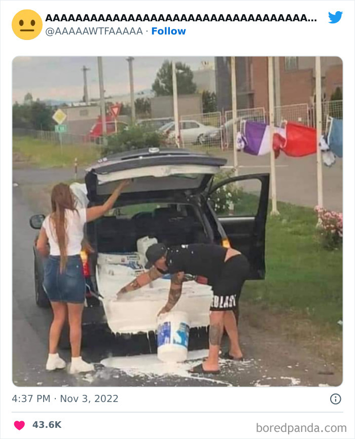 Two people dealing with a paint spill from an SUV, creating a weird and funny scene.