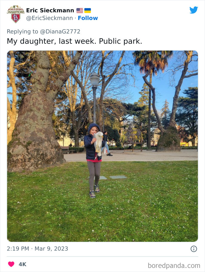 Child in a public park holding a large bird, one of the unhinged kids doing something surprising to freak out onlookers.