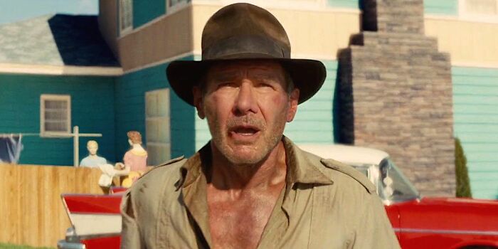 Actor wearing a brown hat and beige shirt in an outdoor scene, representing one of the highest-paid actors of all time.