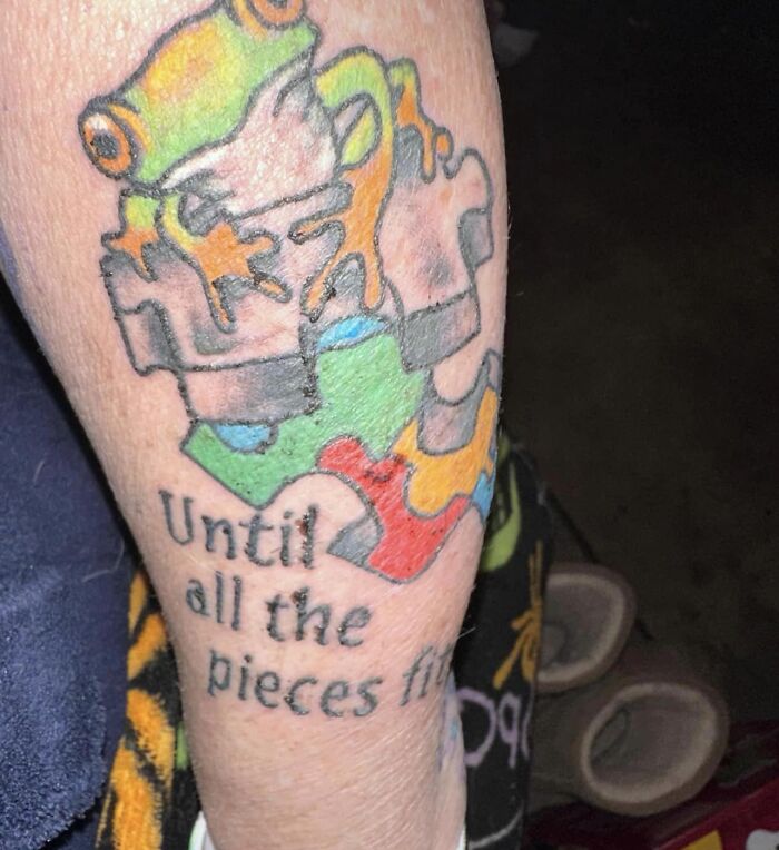 Colorful jigsaw puzzle tattoo with text, representing a permanent mistake.