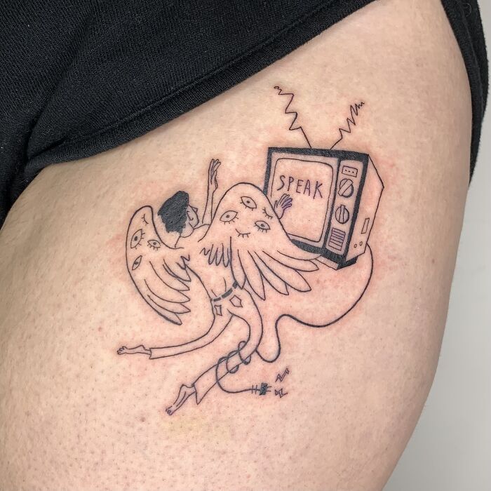 Illustration-style tattoo depicting a surreal winged figure with a TV labeled "Speak" on arm.