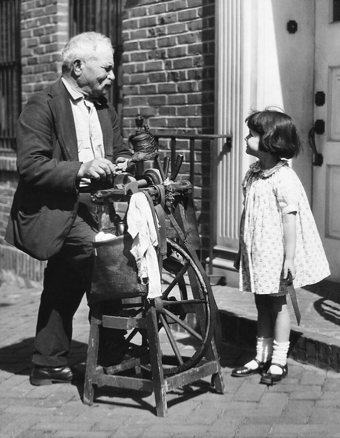 Traveling Knife Sharpener With A Customer. United States, Early 1910s