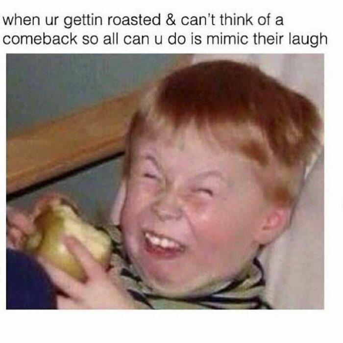 Child laughing humorously while holding a green apple, relating to viral "Evil Kermit" memes.