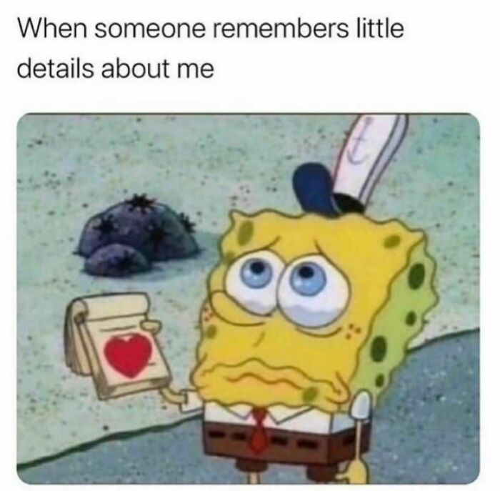 SpongeBob holding a heart notepad, showcasing a relatable meme expression.