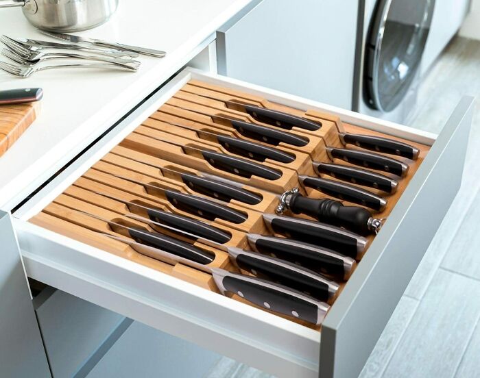 Knife drawer organizer with neatly arranged knives, showcasing efficient home organization.