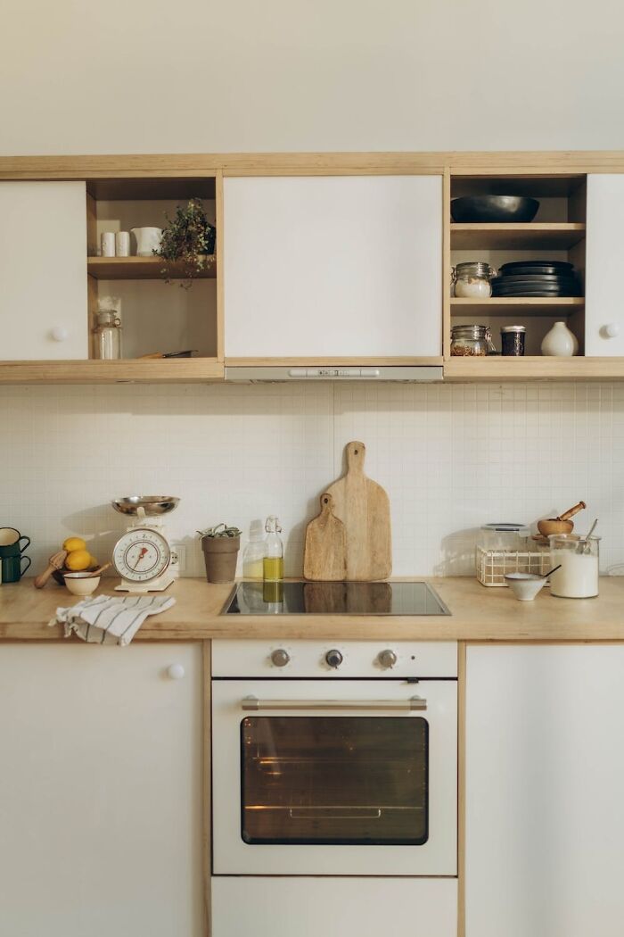 Modern kitchen with organized cabinets and countertop highlighting home organization ideas.