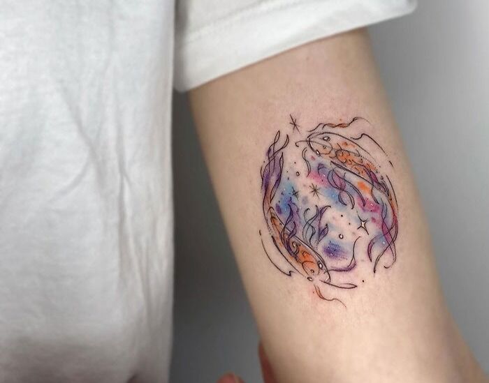 Colorful fish design tattoo on an arm, showcasing creative animal tattoo ideas.