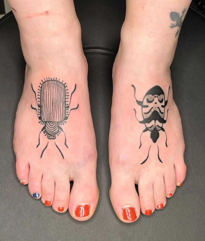 Animal tattoos of beetles on feet with orange nail polish, designed creatively.