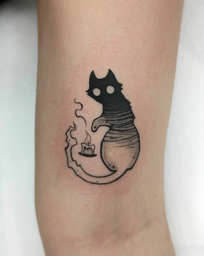 Silhouette cat tattoo with candle, creative animal tattoo design.
