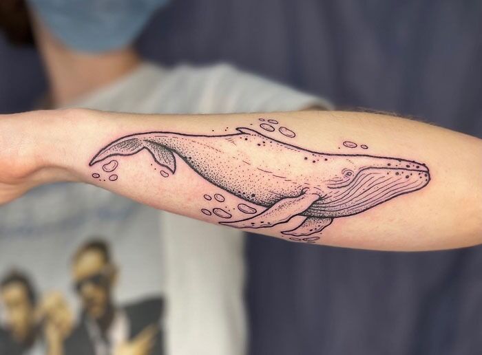 Whale tattoo design on forearm, offering creative ideas for animal tattoos.