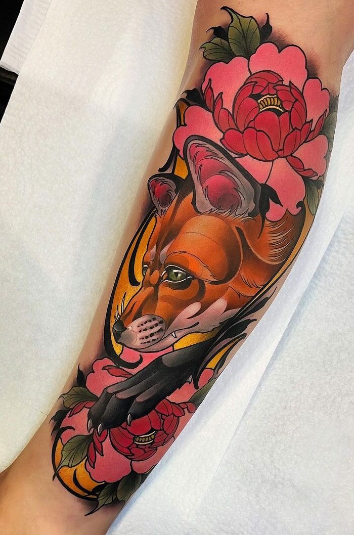 Animal tattoos featuring a colorful fox and floral design on an arm.
