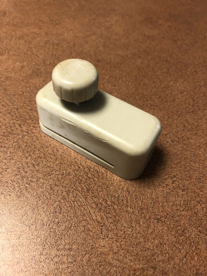 Plastic Device With A Blade That Cuts A Chunk Out Of Paper