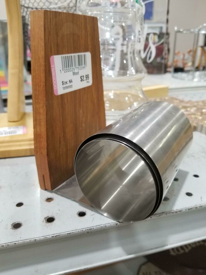 What Is This Coiled Sheet Metal Attached To A Piece Of Wood?