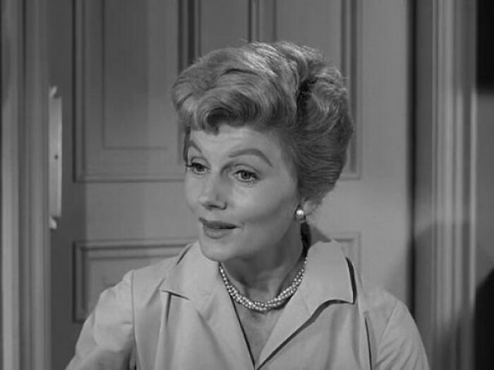 June Cleaver in a shirt is talking