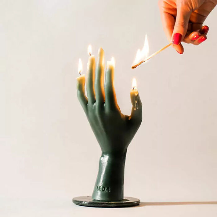person lighting fingers candle 