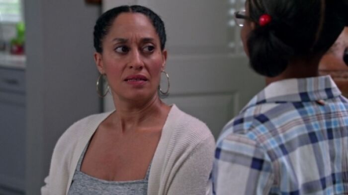 Rainbow Johnson is sitting and talking with girl