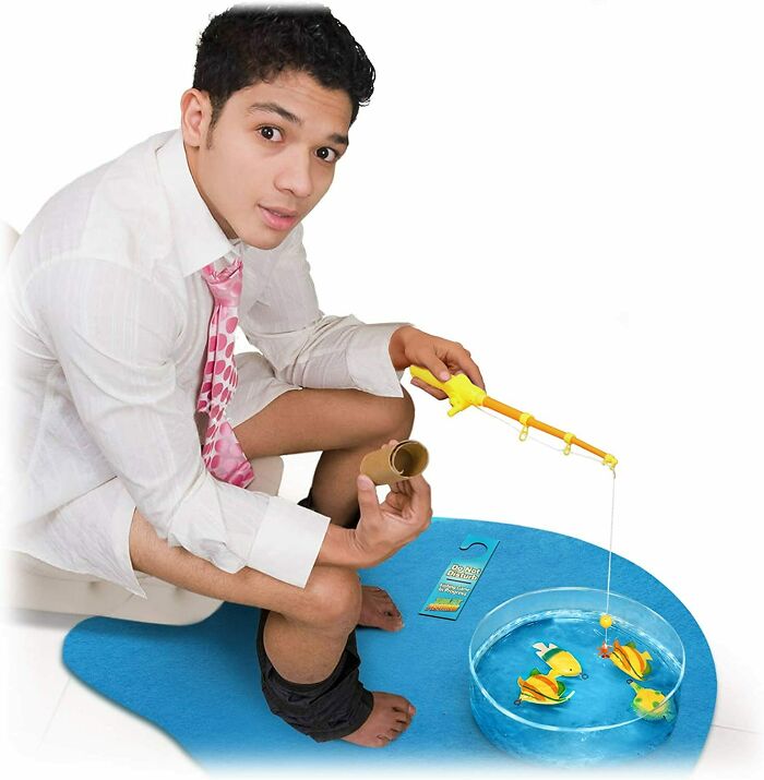 man playing toilet fishing game 