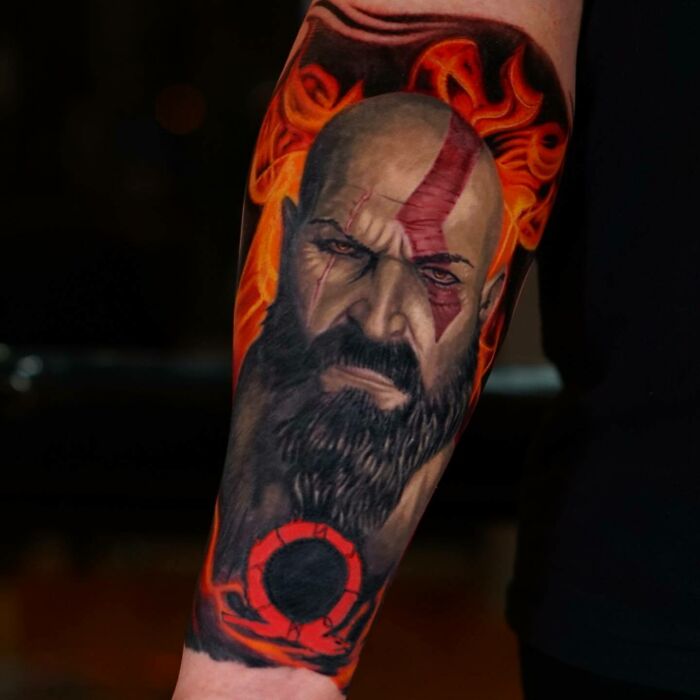 Super realistic tattoo of a bearded warrior with red markings and flames, showcasing incredible detail and artistry.