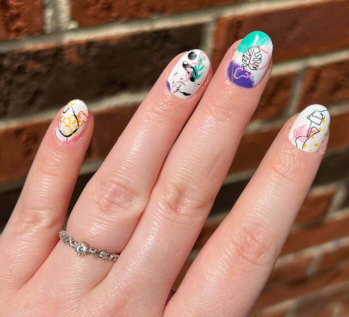 Colorful abstract nail art design on manicured hand, perfect for your next nail appointment.