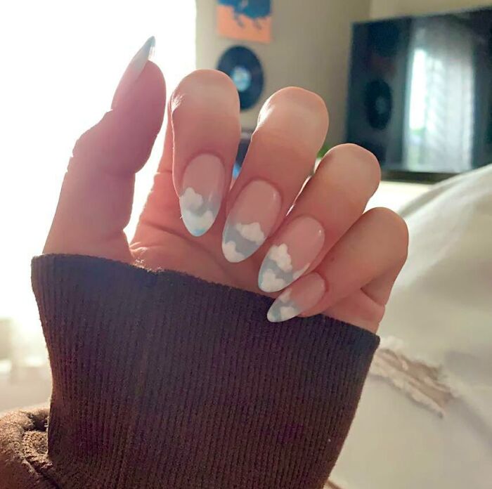 Nail art with a dreamy, cloud design on almond-shaped nails, perfect for your next appointment.