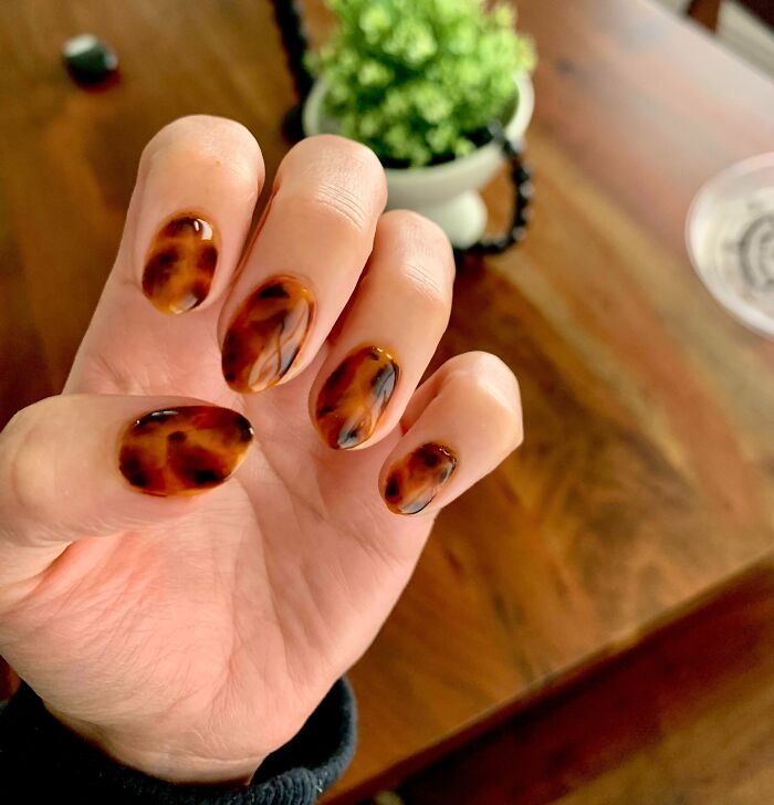Hand with tortoiseshell nail art design, showcasing an idea from insanely good nail art collections.