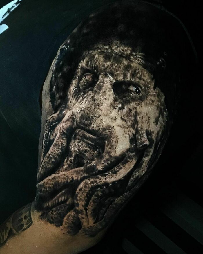 Super realistic tattoo of a detailed octopus face on a person's arm, showcasing artistic skill and depth.