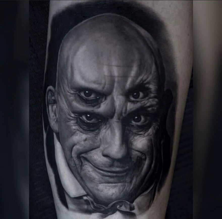 Realistic tattoo of Uncle Fester with four eyes, showcasing detailed artistry.