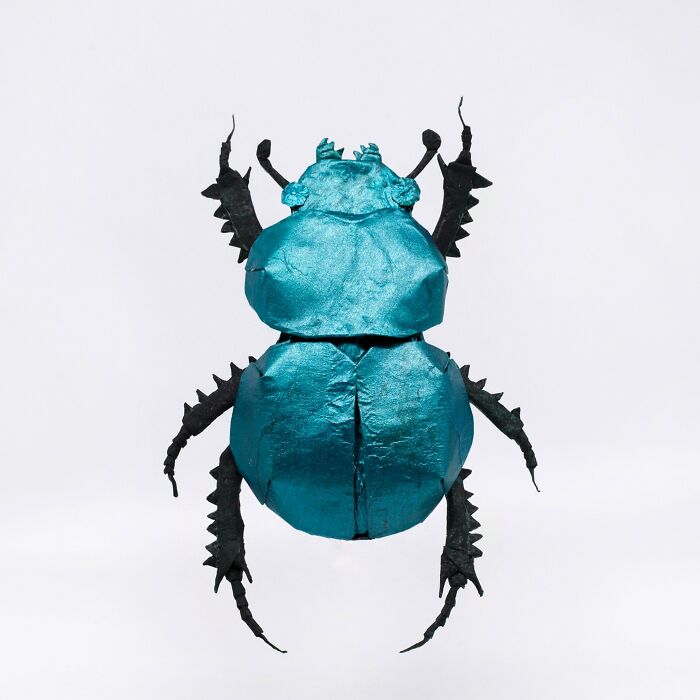 a turquoise origami of dung beetle