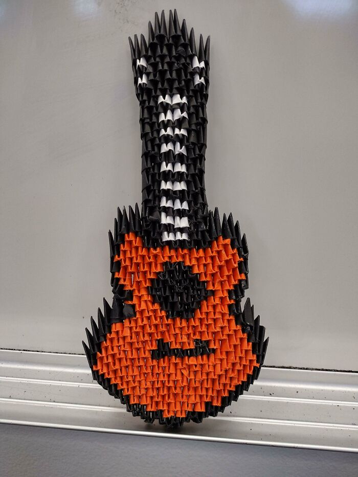 red and black guitar made out of a paper