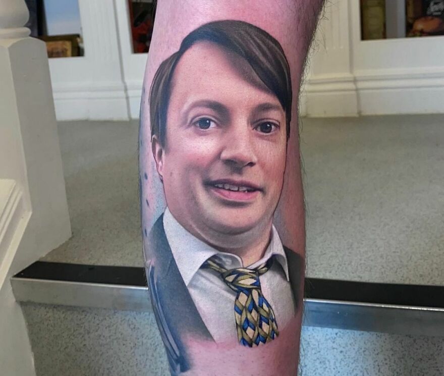 Realistic tattoo of a man's face on a leg, showcasing detailed artistry and museum-worthy quality.