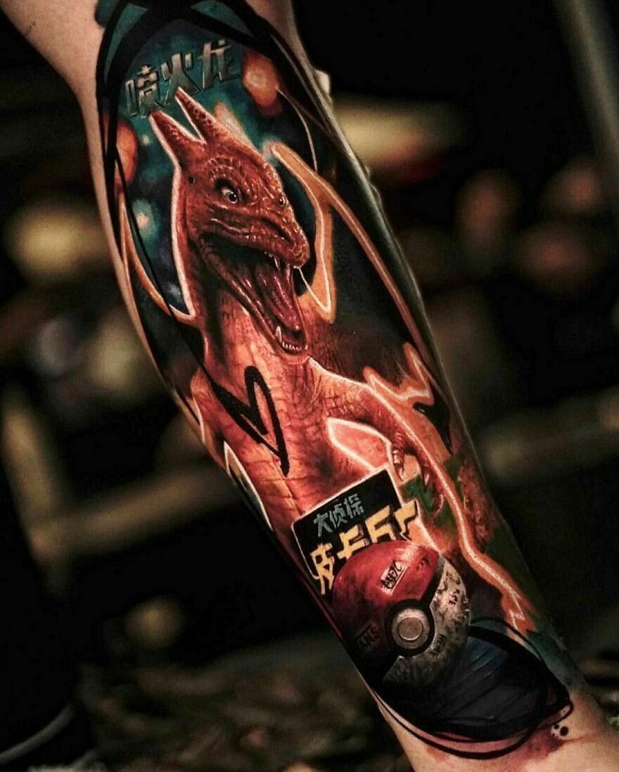 Realistic Charizard and Poké Ball tattoo showcasing intricate detailing.
