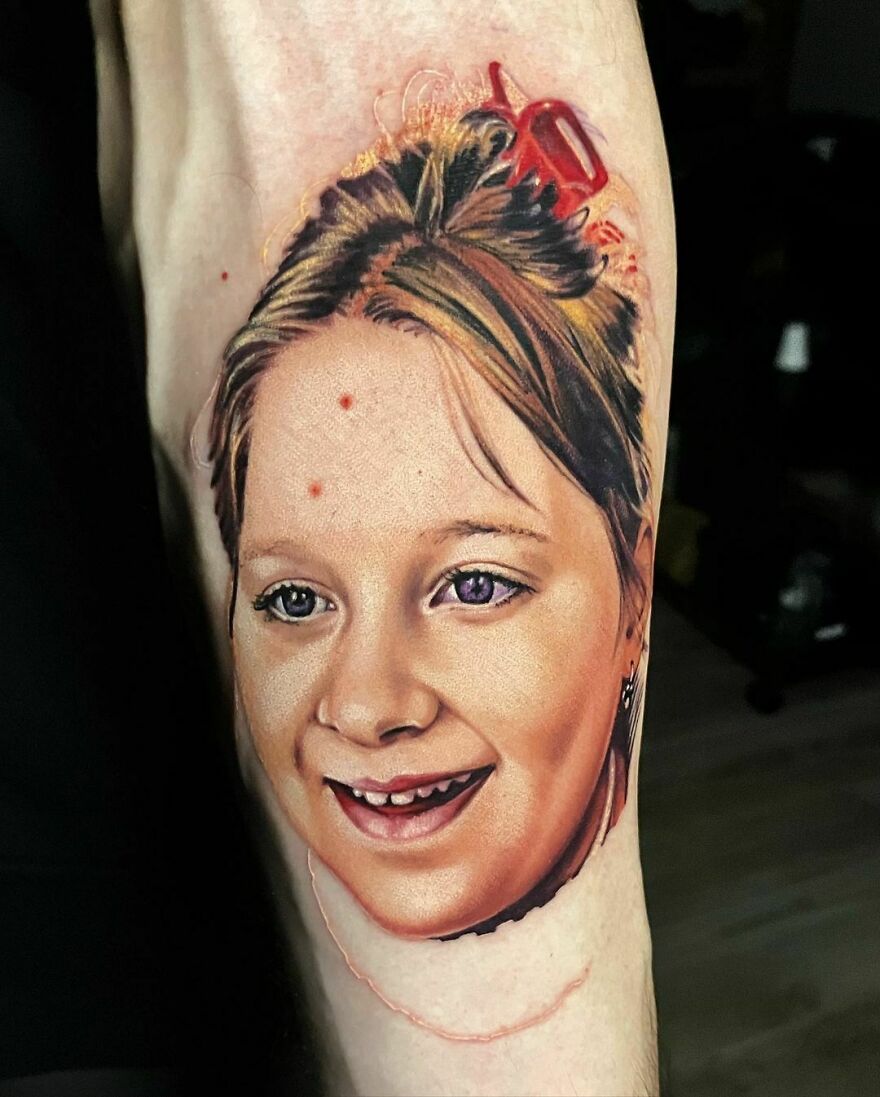 Super realistic color tattoo of a girl's portrait, showcasing intricate detailing on the arm.