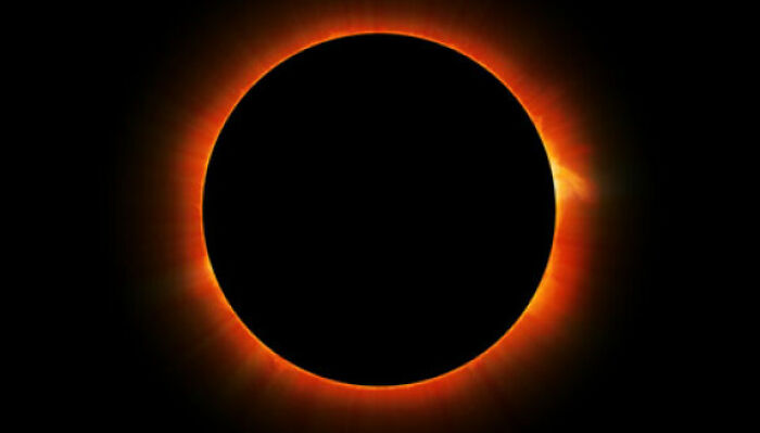 Solar eclipse with a glowing red circle highlighting the obvious celestial event.