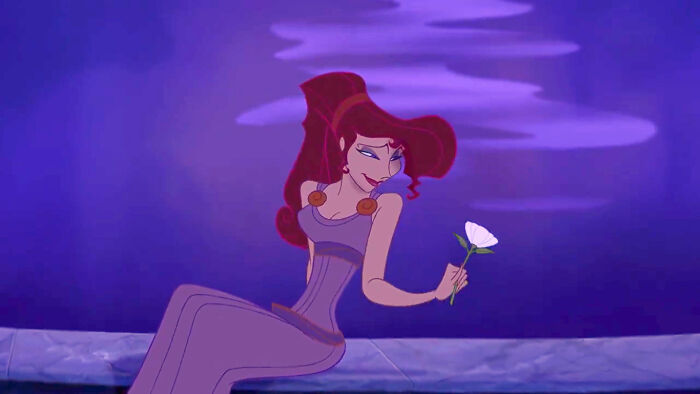 Megara holding white flower 