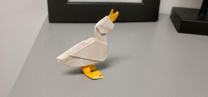 a white and yellow duck made out of the paper