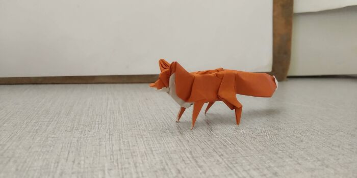 a red and white fox made out of the paper