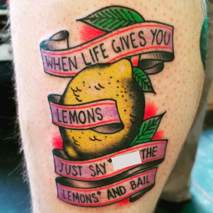 Word tattoo of a lemon with a humorous banner saying "When life gives you lemons."