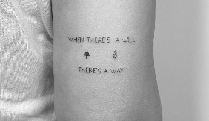 "Creative word tattoo saying 'When there's a will, there's a way' with minimalist tree symbols on an arm."
