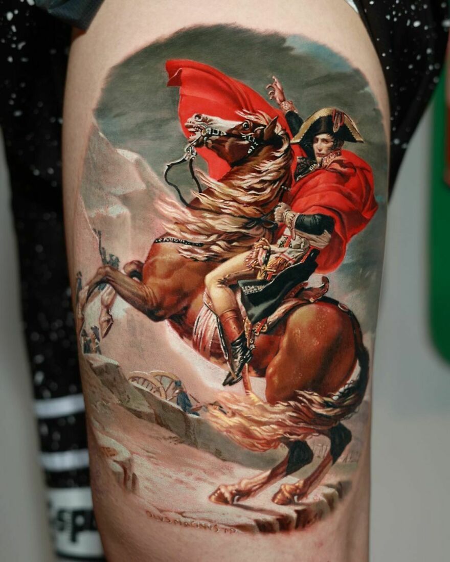 Realistic tattoo of Napoleon on a horse crossing the Alps, showcasing intricate detailing and vivid colors.