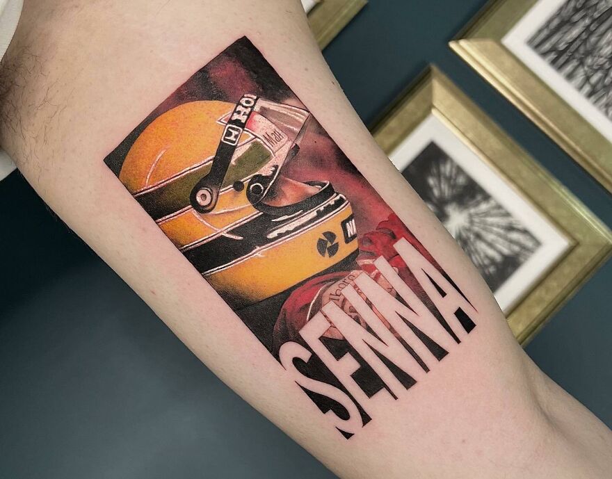 Realistic tattoo of a yellow helmet with "SENNA" letters, featuring detailed artwork.
