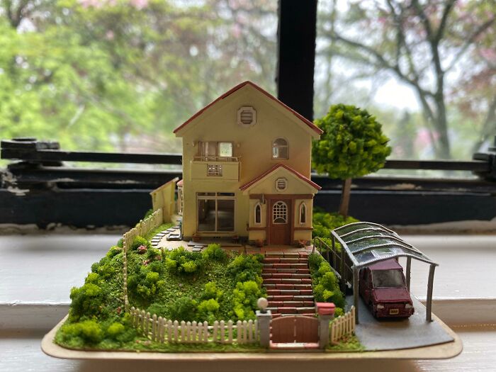 paper house with a vegetable garden and car nearby